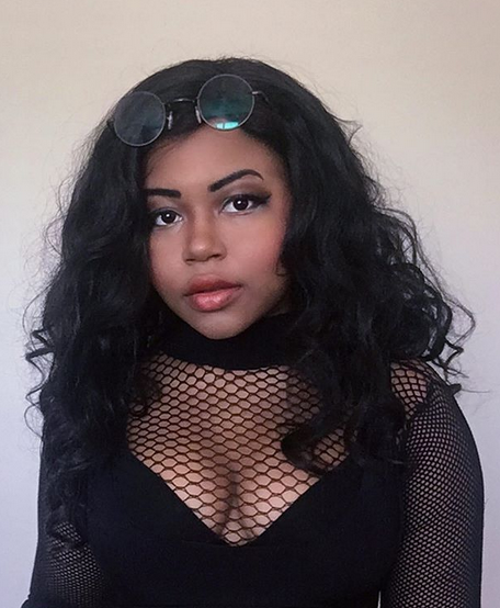 Young lady wearing round glasse up on her head